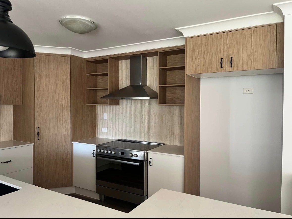 Light-wood U-shape kitchen with stone benchtop