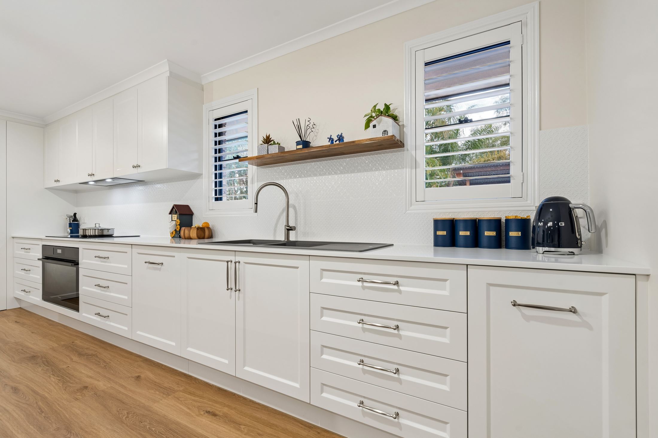 PMG Cabinetry kitchen — sink run, window and timber shelf, Placid Hills