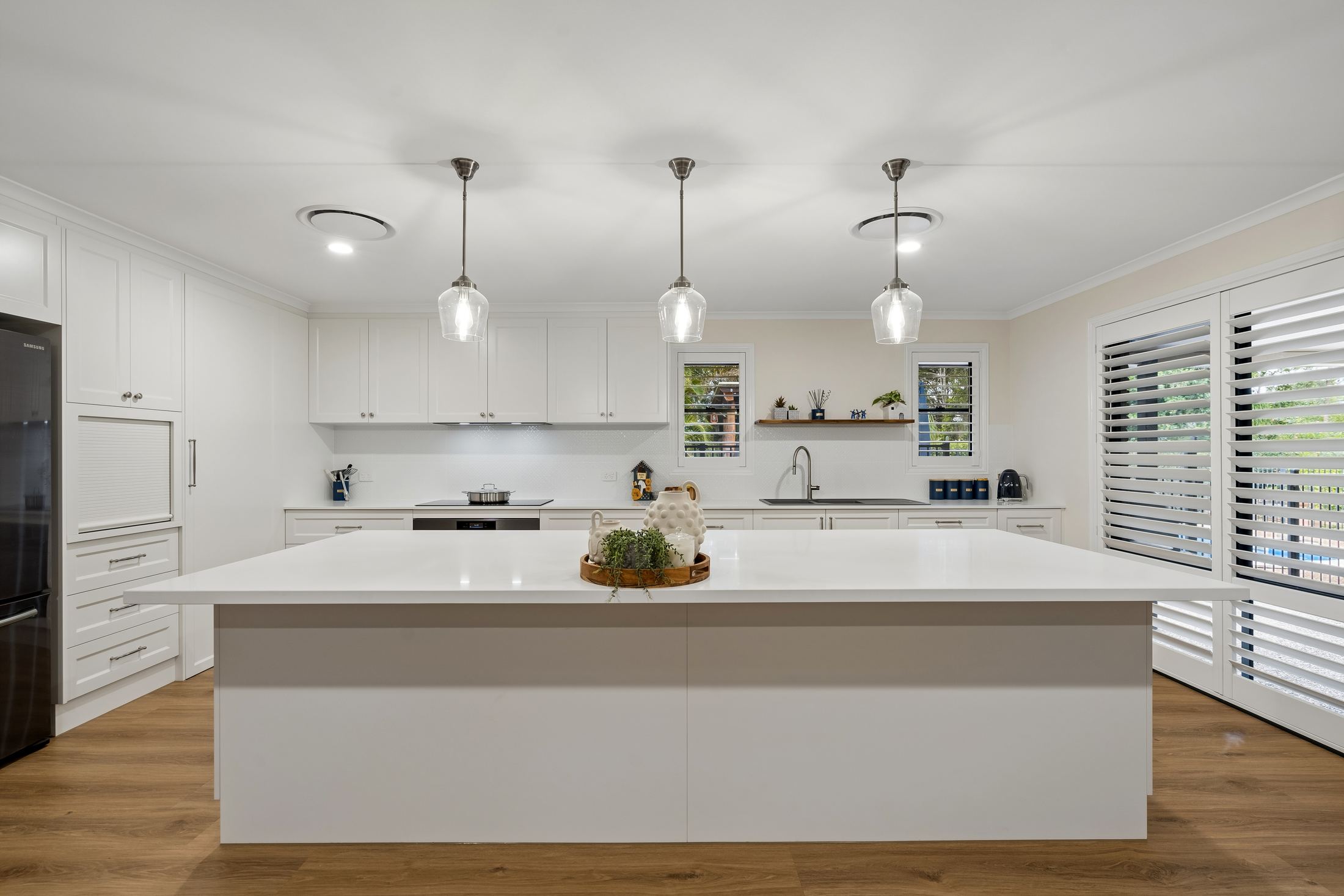 Full PMG Cabinetry kitchen — Shaker doors, stone island bench, oak floors